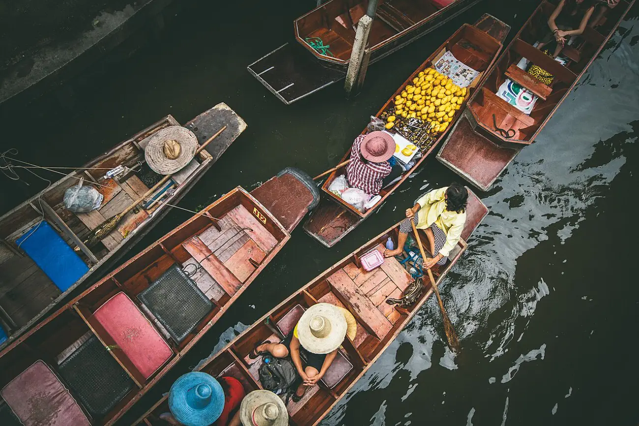 Boats loaded with produce packed together at a floating market
