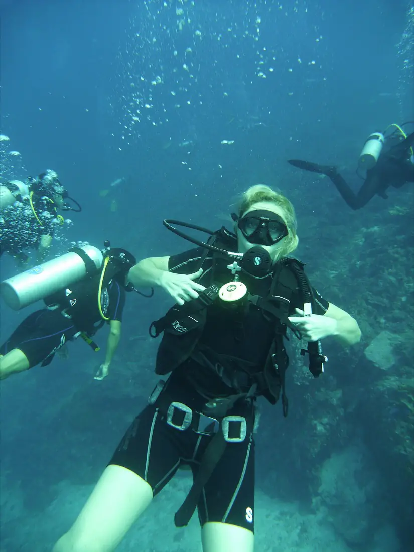 Divers in the water beside the boat at the Similan Islands