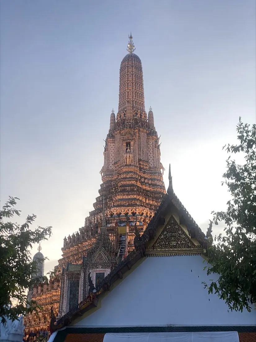 Wat Arun lit against the evening sky above the Chao Phraya